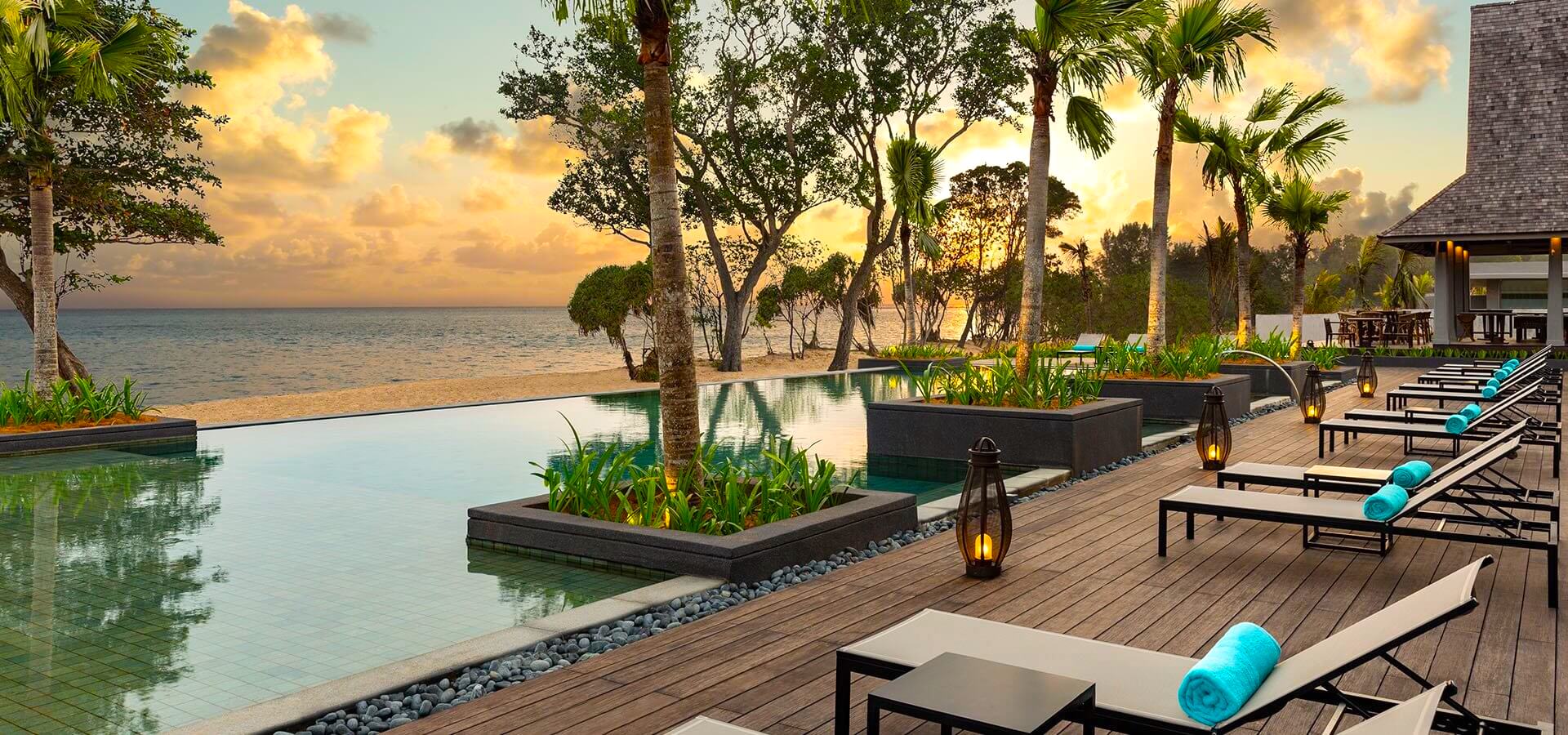 swimming pool and sunset view overlooking the beach at Anantara Desaru Coast Residences