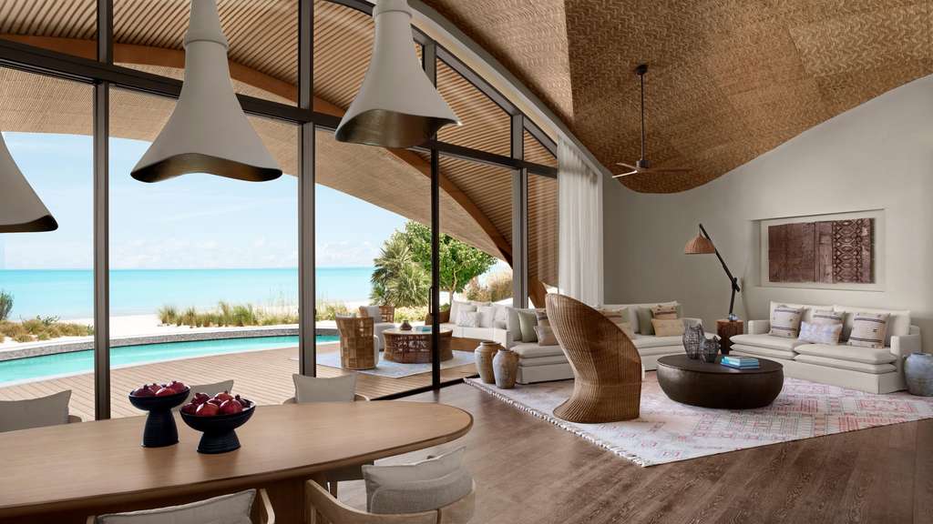 Interiors prioritize understated elegance. Neutral palettes of beige, ivory, and soft greys are accented by handwoven rugs, locally crafted ceramics, and wooden furnishings inspired by Saudi artistry.