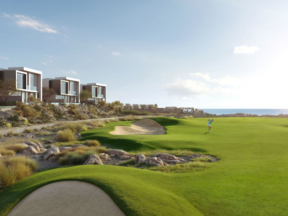 Trump Golf Villas positioned along the Trump International Championship Golf Course, with open golf and sea views.